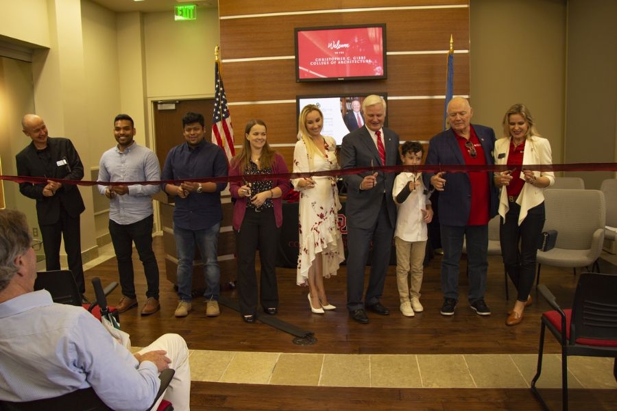 Chris and Ania Gibbs, alongside President Gallogly, Dean Hans E. Butzer, family, and students, cut a ribbon in recognition of the naming of the Christopher C. Gibbs College of Architecture.