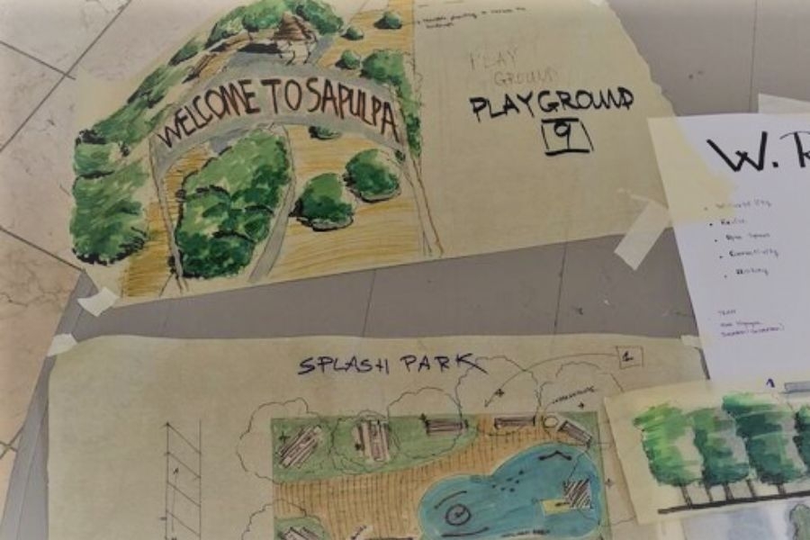 Architectural and landscape sketches on trace paper taped to a wall
