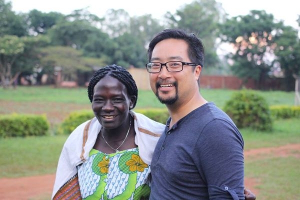 Christopher Le and a woman in a field posing for a photo