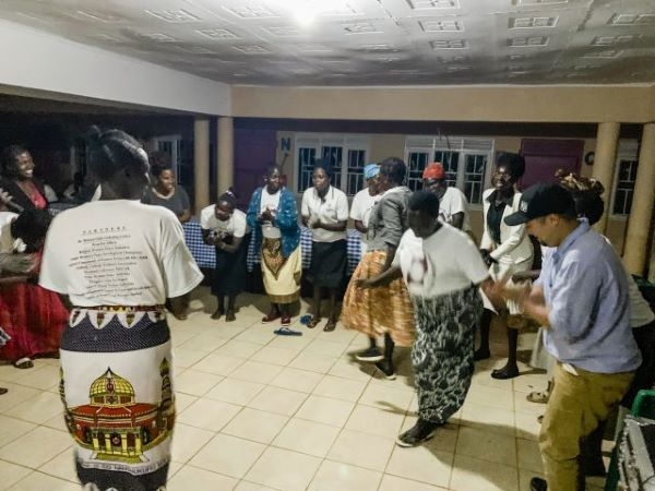 Participants gathered around a dance floor during a cultural night at the conference.