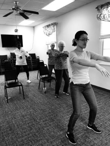 Pai Liu instructing a group of senior citizens in a tai chi class at Clemson University.