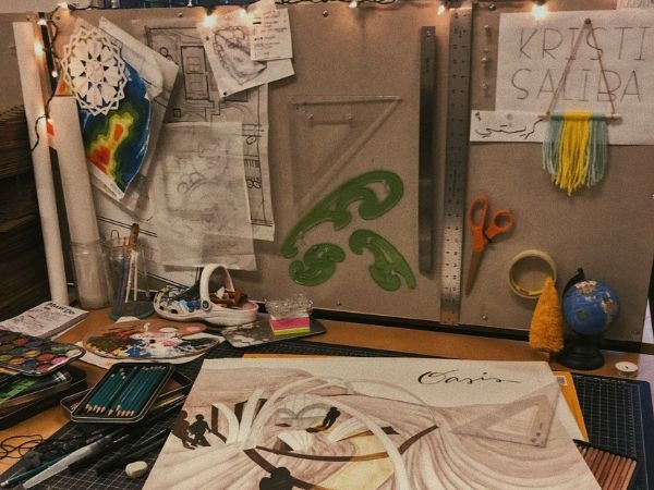 Picture of highly decorated and personalized desk area of Kristin Saliba's desk in architecture studio.