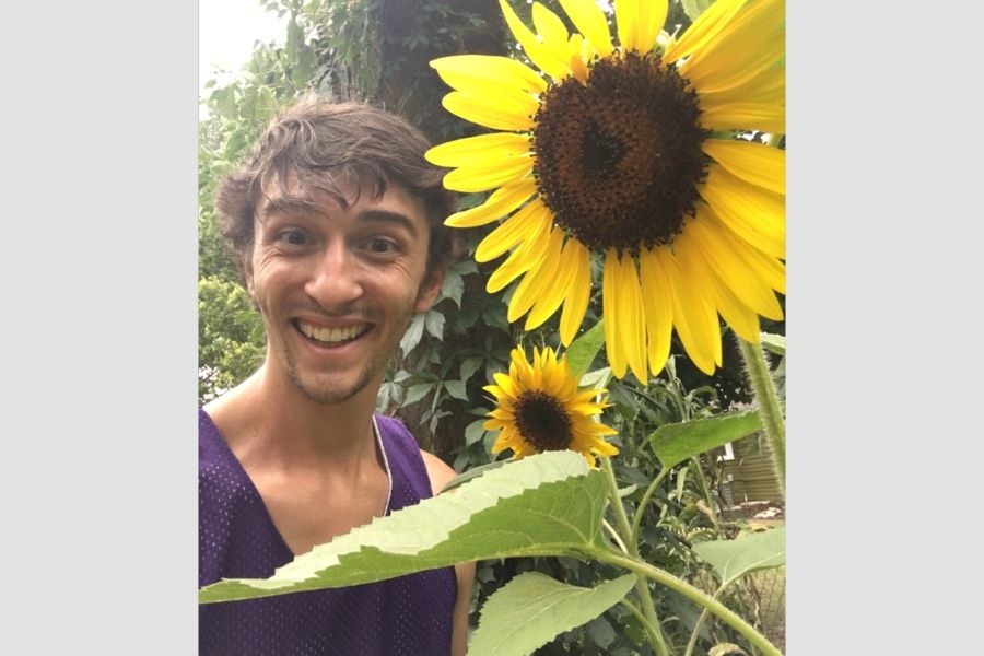 Kevin Mink with a large sunflower.
