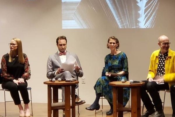 Panelists sitting on stage