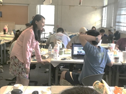 Cheng with students in her design studio course. 