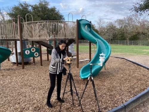 Cheng collecting microclimate data at a playground.
