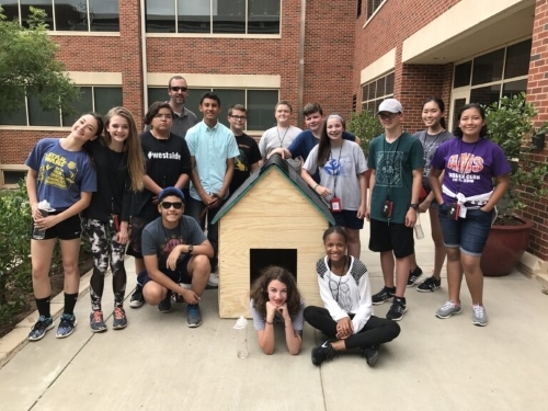 Reyes with students and their project completed during summer camp.