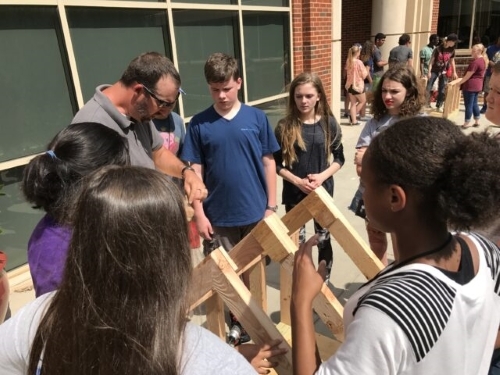 Reyes working with students at summer camp outside of Gould Hall. 