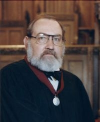 Jim Sealy posed for a professional photo wearing a medal.