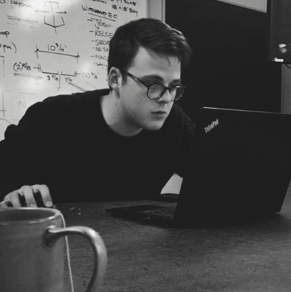 Ben DeCuyper working on a ThinkPad laptop.