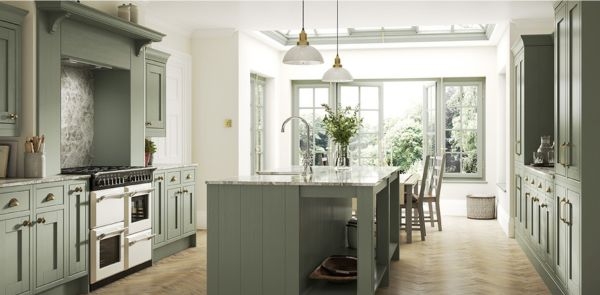 Picture of interior kitchen and eating space with sage green colored cabinetry. 