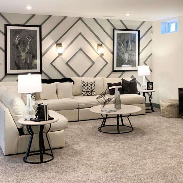 Interior picture of living room space with warm white and grey and an accent wall with geometric pattern. 