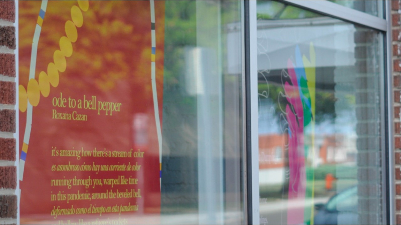 Poetry artwork displayed in a storefront window as part of the Food Odes installation in Oklahoma City.