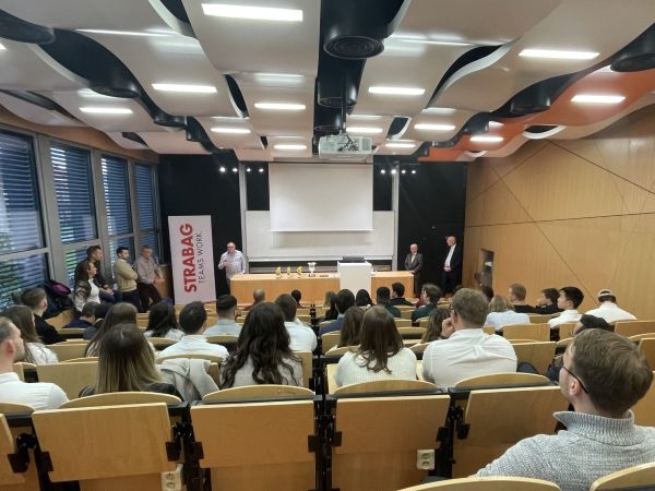 An auditorium and a desk with trophies on it.