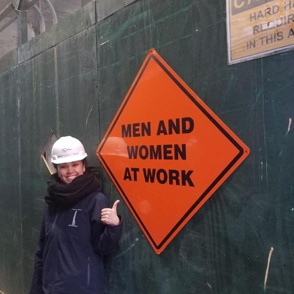 Esin Pektas with a sign that says "men and women at work".