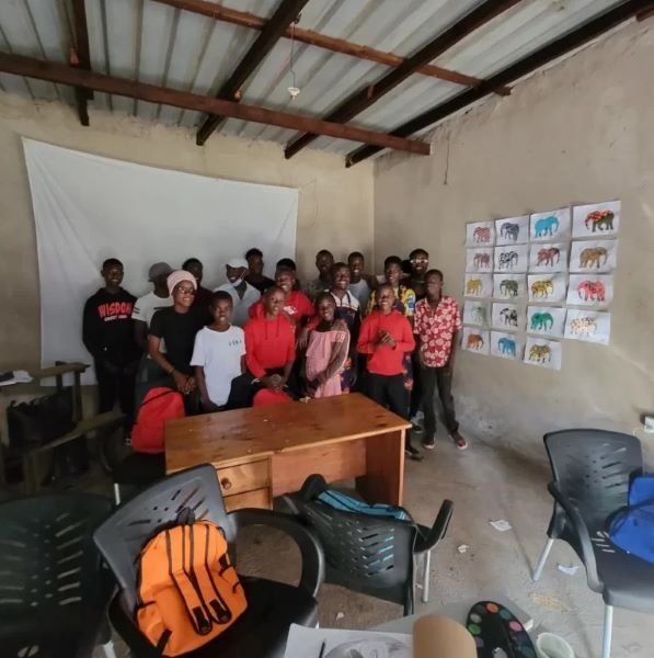 Workshop participants with their paintings.