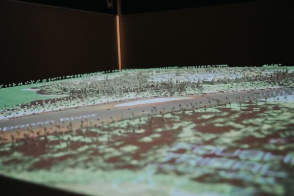 A close-up view of a scale model with a map projected on to it.
