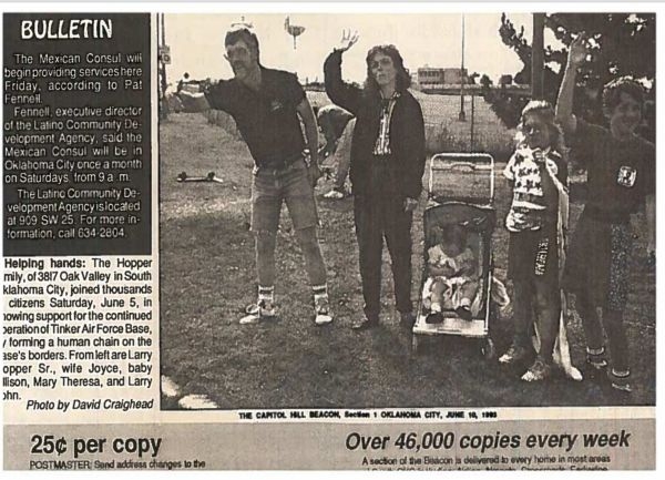 A newspaper photograph of Larry Hopper with his wife and kids.