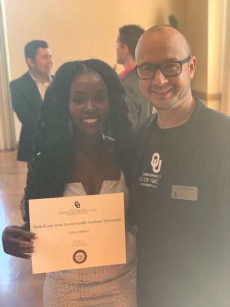 Grace Olaleye with Hans Butzer, holding a scholarship certificate.