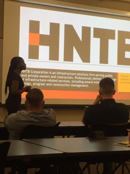 Grace Olaleye giving a presentation about H N T B.