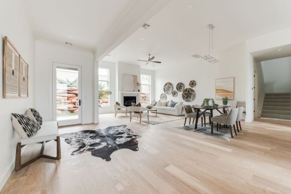 A living room with stairs and back door.