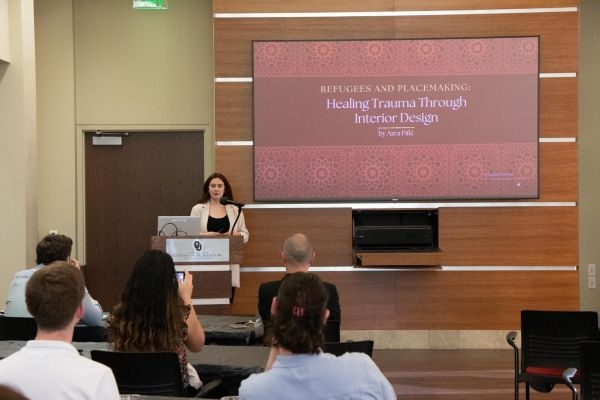 Azra Fific with her title slide "Refugees and Placemaking: Healing Trauma through Interior Design".