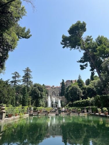 Dean Hans Butzer fist bumping a student in a lecture hall.