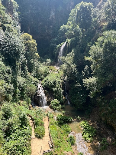 A lush valley with waterfalls.