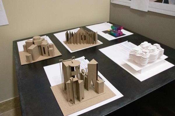 Three-dimensional scale models with project details.