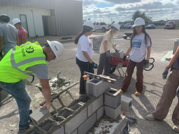 Construction Science students laying concrete masonry units.