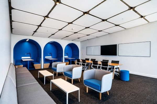 A work space with bright blue alcoves.