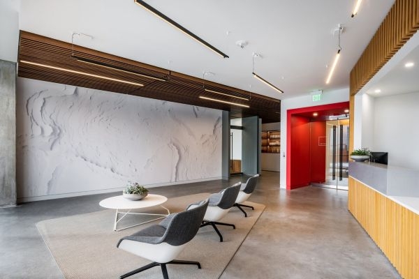 A waiting room with a bright red accent near the door.