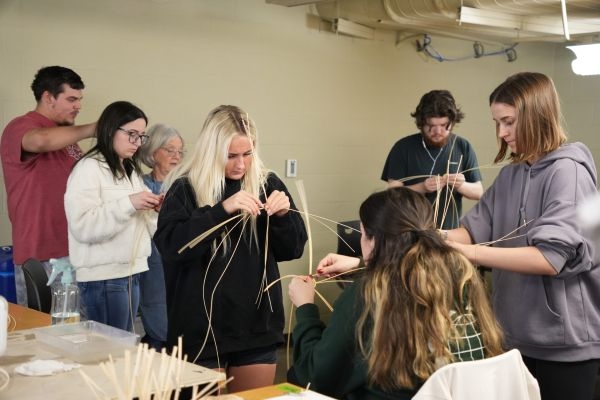 Students focused on weaving.