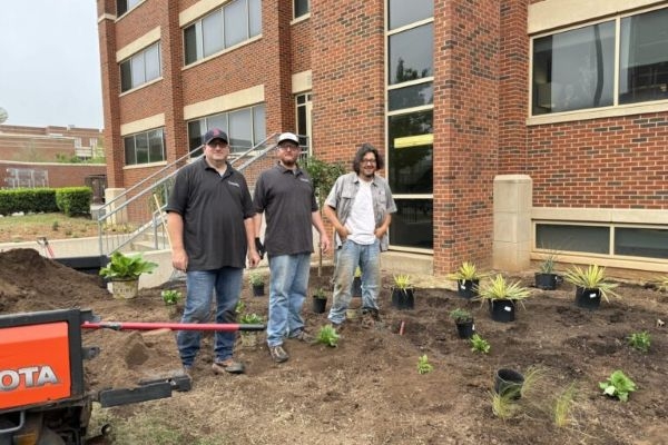 Justin Jones with O U Landscape Services employees.