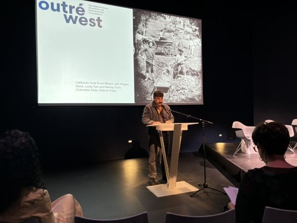 Marco Piscitelli presenting a slide entitled "Outré West".