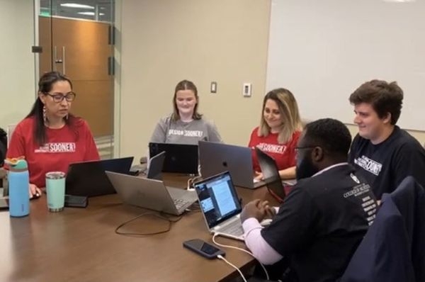 Team members presenting their proposal over video call.