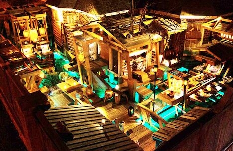 A ship-like courtyard with blue illumination at ground level resembling water.