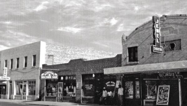 A historic photo of the Jewel Theater and surrounding buildings.