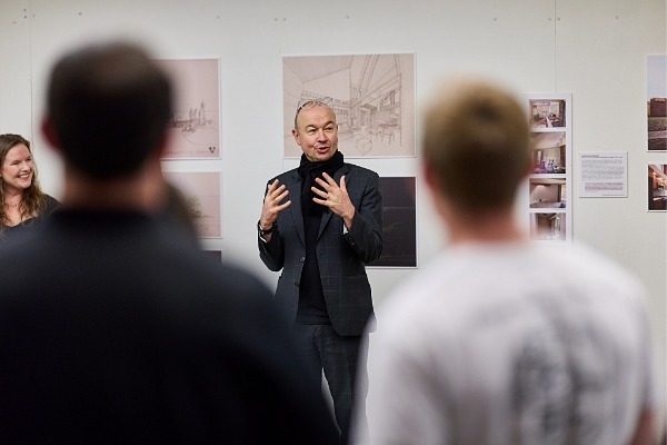 Dean Butzer speaking to a crowd of people. 