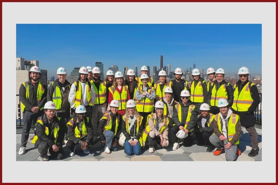 Architecture students and faculty in hard hats and hi-vis vests in New York City.