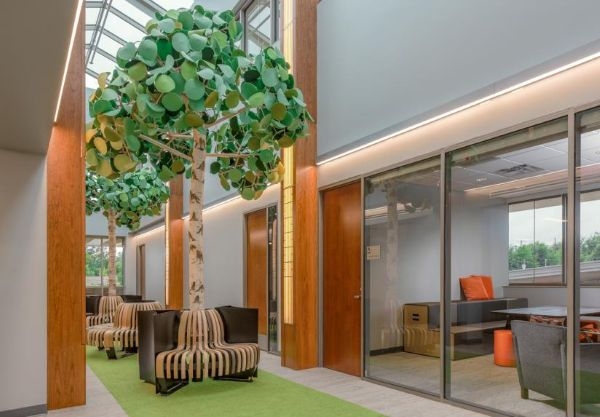A hallway with benches shaped like growing trees.
