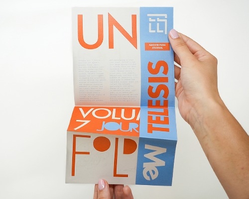 A pair of hands unfolding a section of Telesis. 