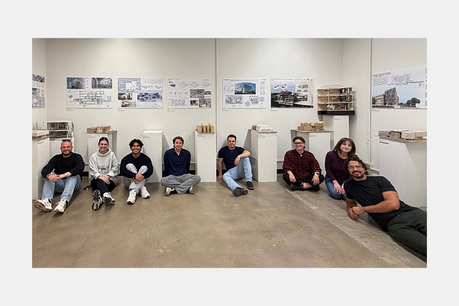Graduate Architecture students sitting on the floor at the Visual Arts exhibit.