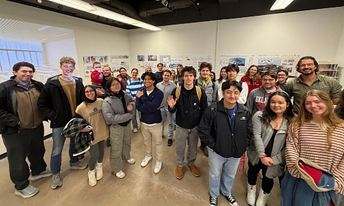Graduate Architecture students group around the Visual Arts exhibit. 
