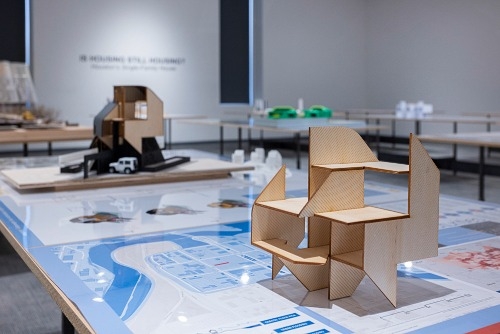Home models on a display table at the Is Housing Still Housing exhibit. 