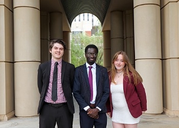 Three O U students standing outside of Gould hall. 