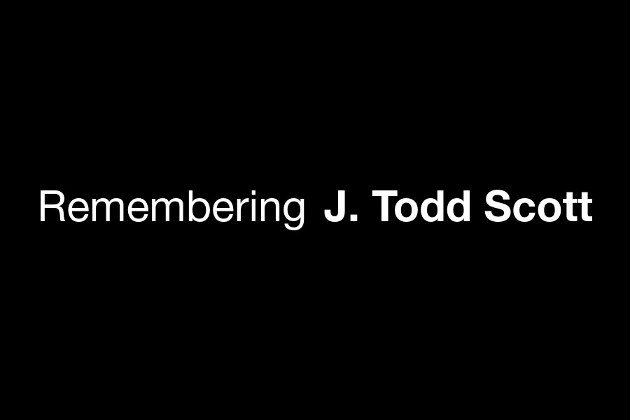 Black graphic with the text Remembering J. Todd Scott. 