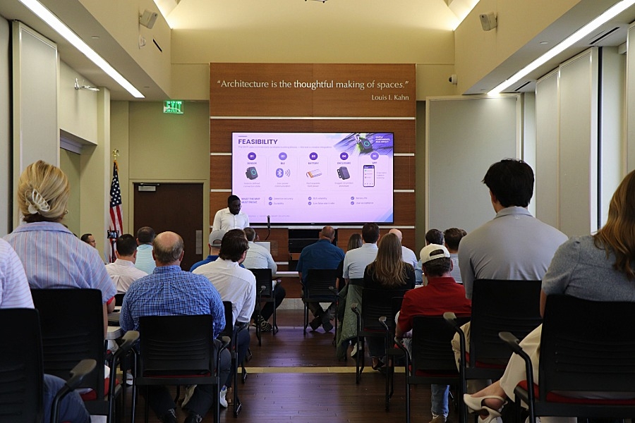 Group of people sitting and watching a presentation. 