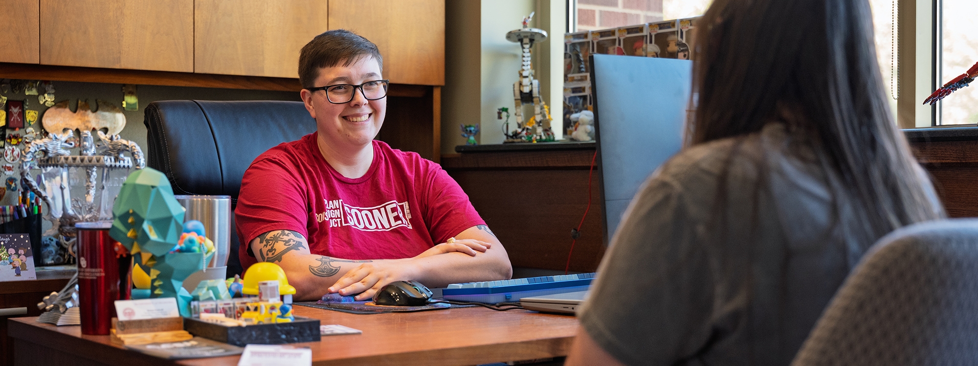 An advisor meeting with a student in an office.