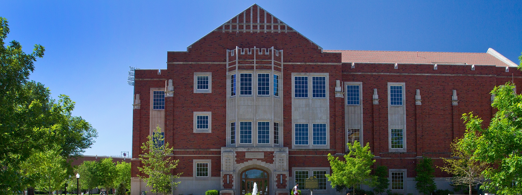 Price College of Business building on a clear sunny day.